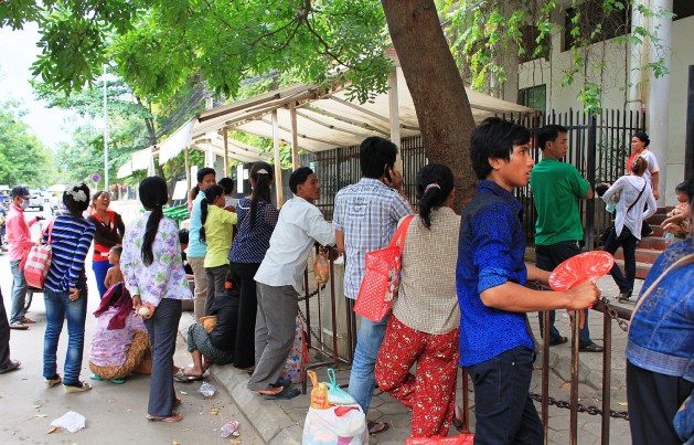 Parents wait anxiously outside a Phnom Penh hospital. Credit: Vincent McIsaac/IPS
